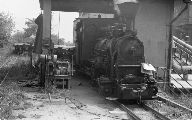Fotografie Jednička na výsypce přebírá prázdné vozy. Vlevo od lokomotivy je vidět vrátek, kterým se souprava při vykládání posunovala.